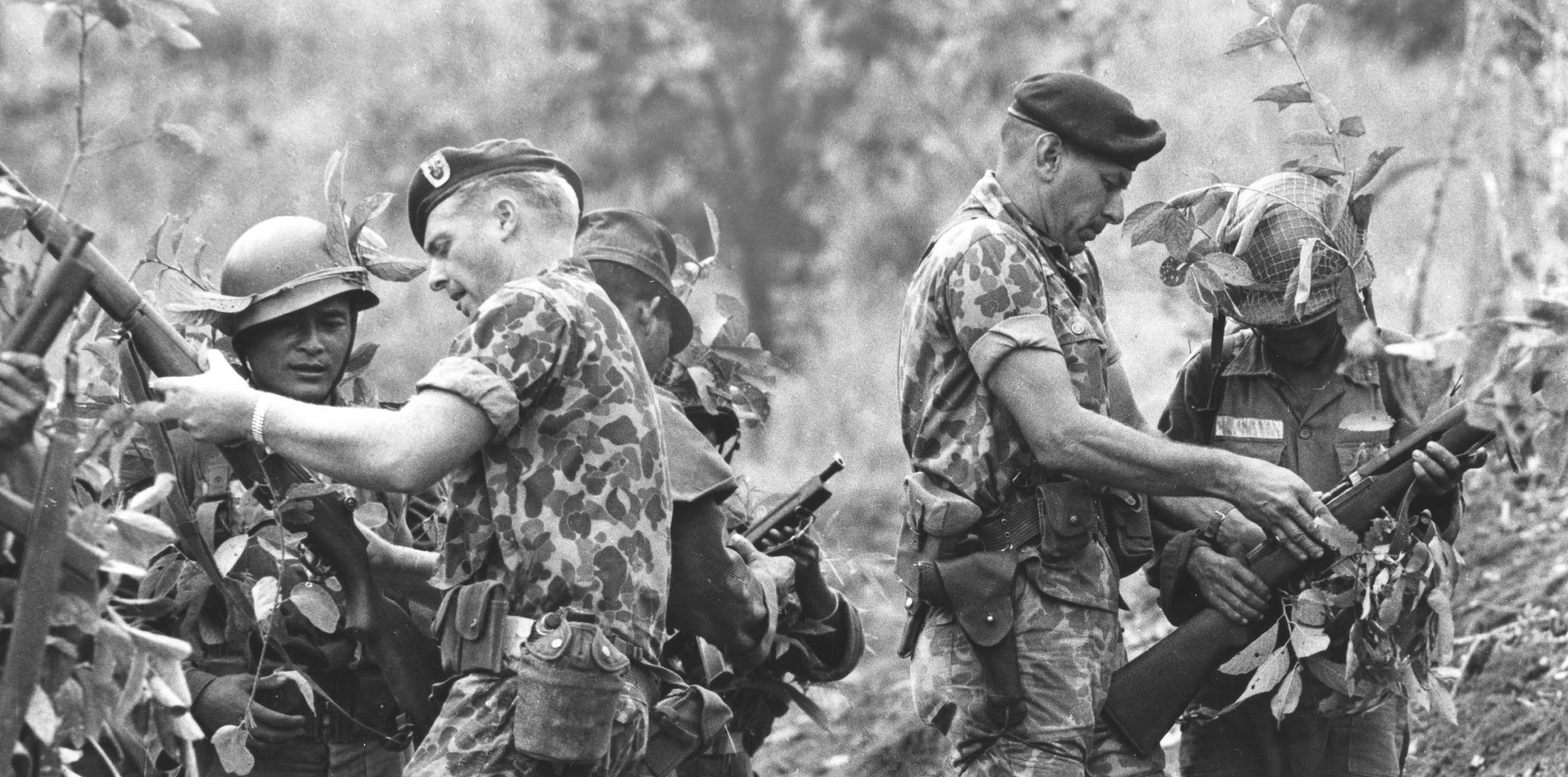 Green beret commanders checking the gear of their men in Vietnam. 